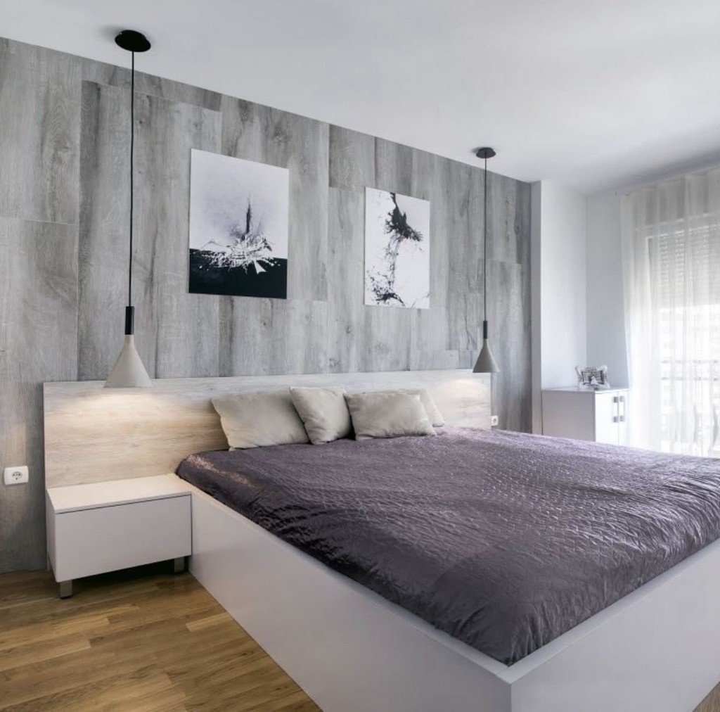Bedroom with a grey wood-texture feature wall, built-in light oak headboard and white platform bed
